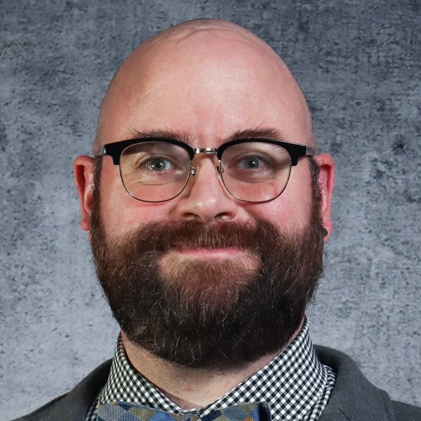 Smiling man with beard and glasses